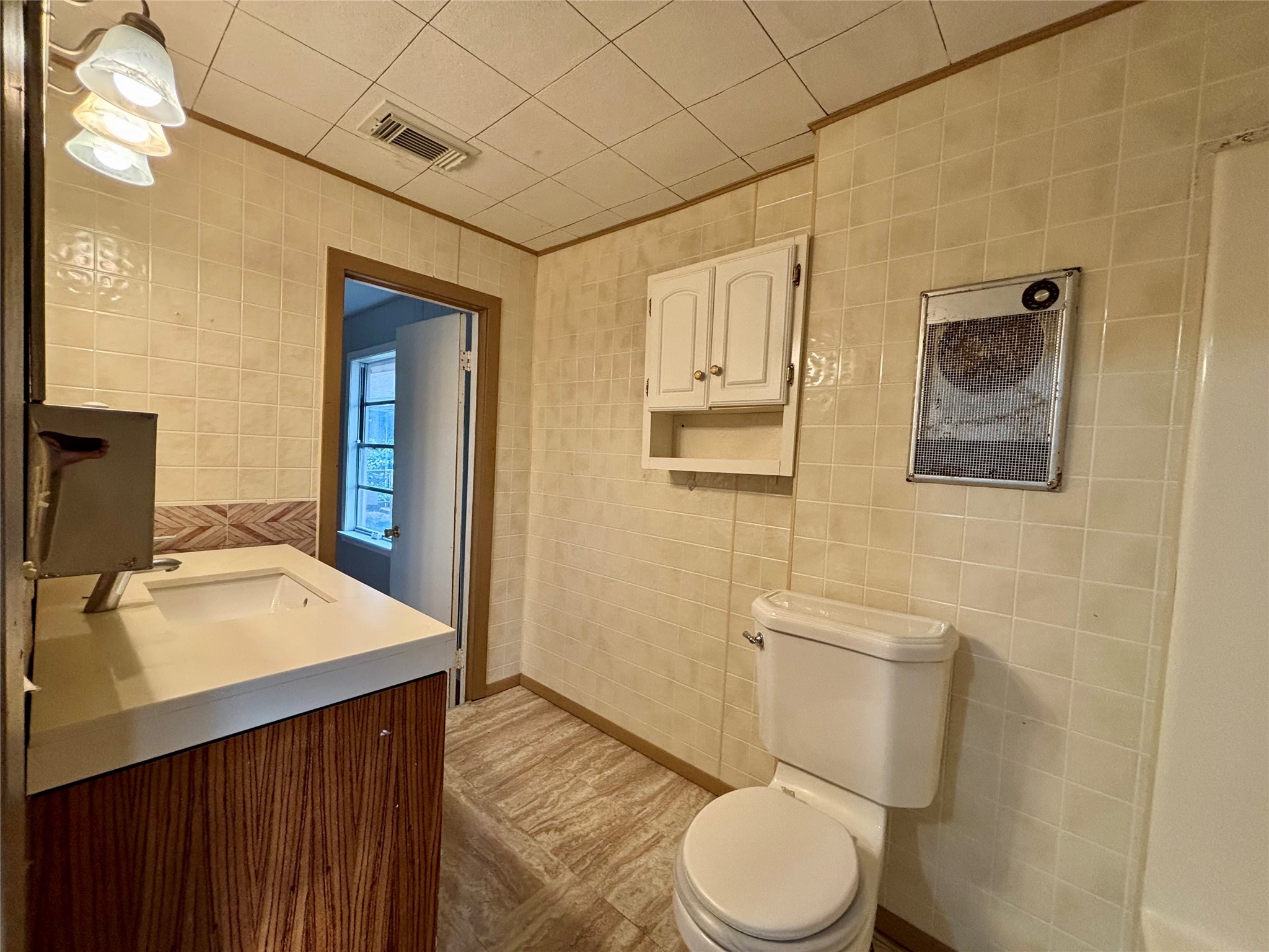 706 West 7th Street Freeport, TX 77541 - Photo 6 of 22 a bathroom with a sink vanity mirror and toilet
