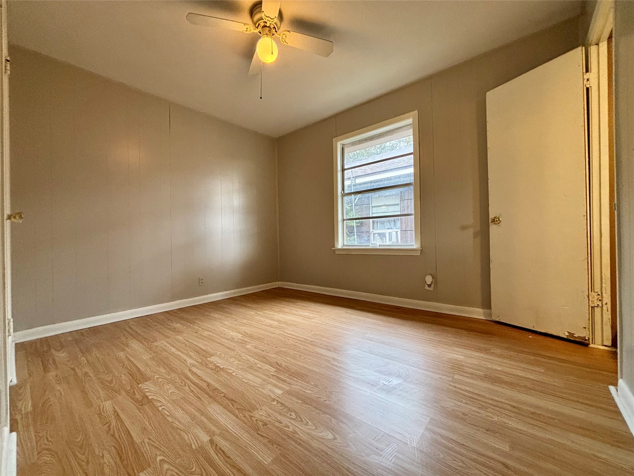 706 West 7th Street Freeport, TX 77541 - Photo 8 of 22 a view of an empty room with wooden floor and a window
