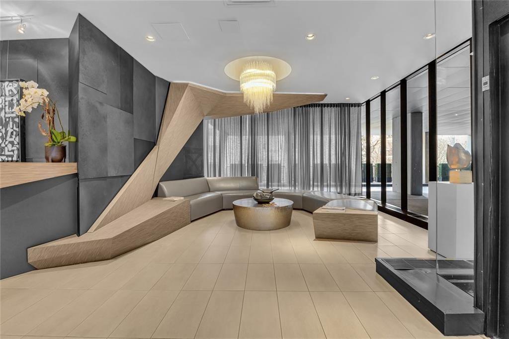 145 15th Street Northeast, Unit 409 Atlanta, GA 30361 - Photo 13 of 23 a lobby with furniture and floor to ceiling window