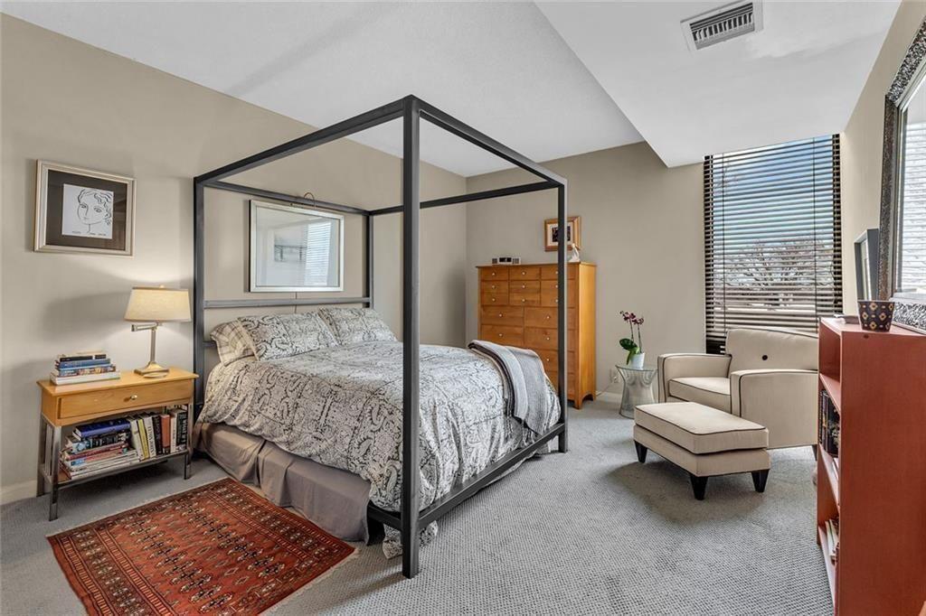 145 15th Street Northeast, Unit 409 Atlanta, GA 30361 - Photo 9 of 23 a bedroom with a bed and a couch