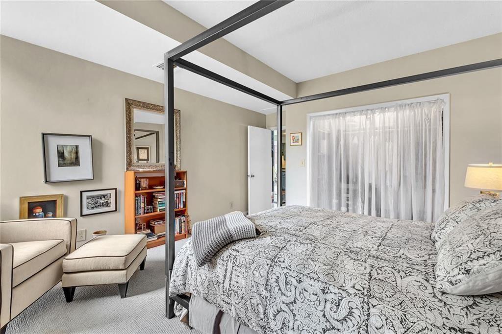 145 15th Street Northeast, Unit 409 Atlanta, GA 30361 - Photo 10 of 23 a bedroom with a bed furniture and a large window