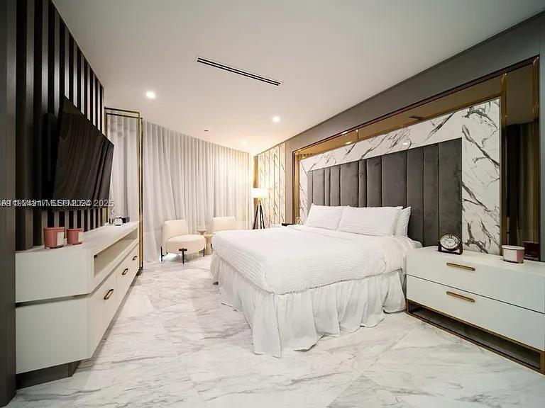 851 Northeast 1st Avenue, Unit 4811 Miami, FL 33132 - Photo 12 of 30 a bedroom with a bed and a flat tv screen on dresser