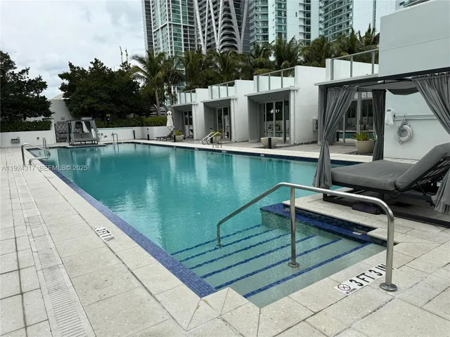a view of a swimming pool with chairs