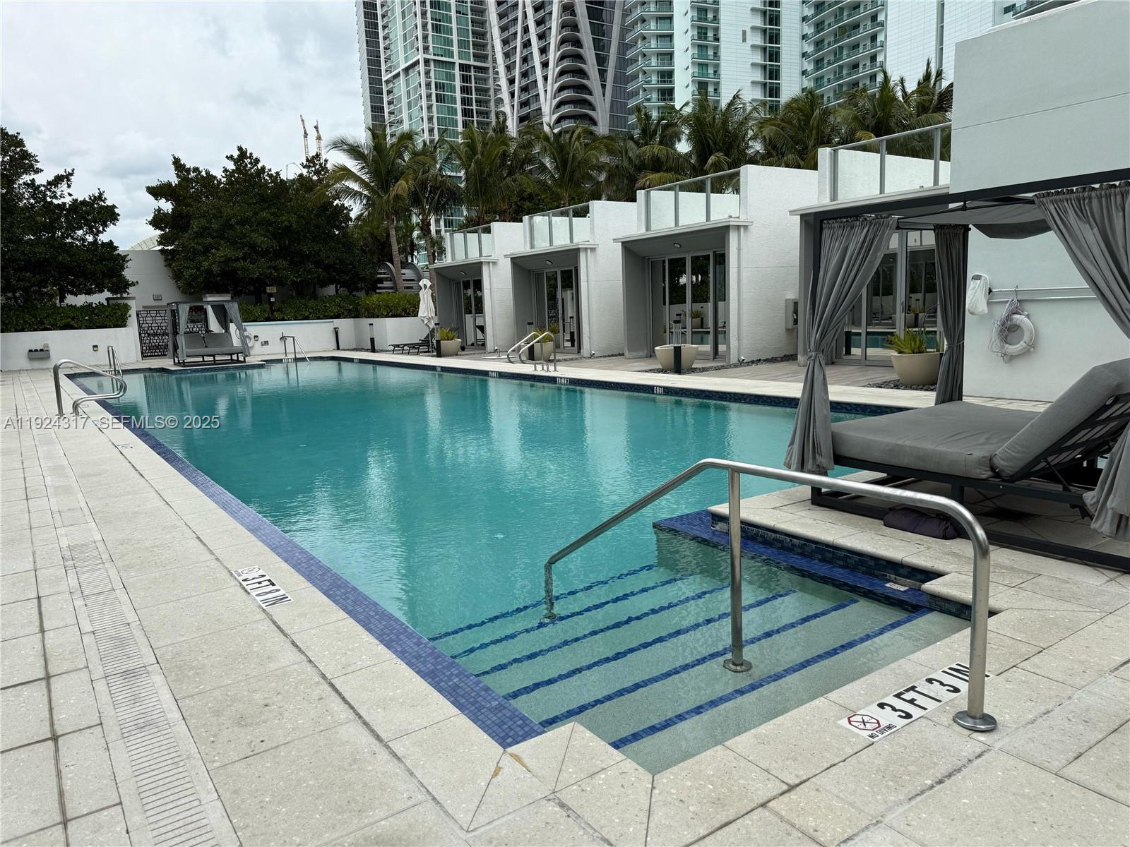 851 Northeast 1st Avenue, Unit 4811 Miami, FL 33132 - Photo 20 of 30 a view of a swimming pool with chairs