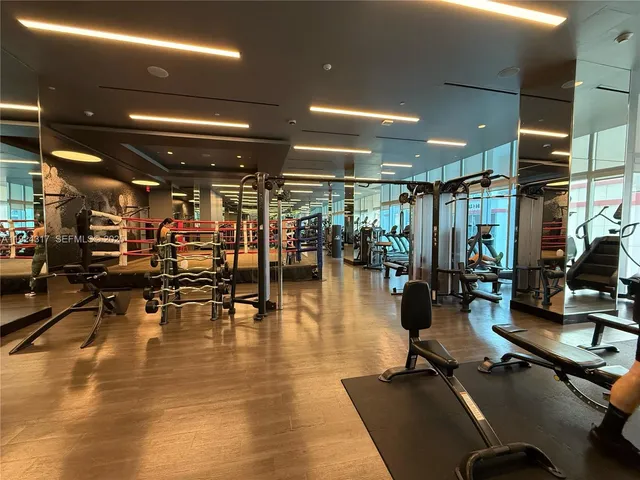 a gym room with lots of gym equipment