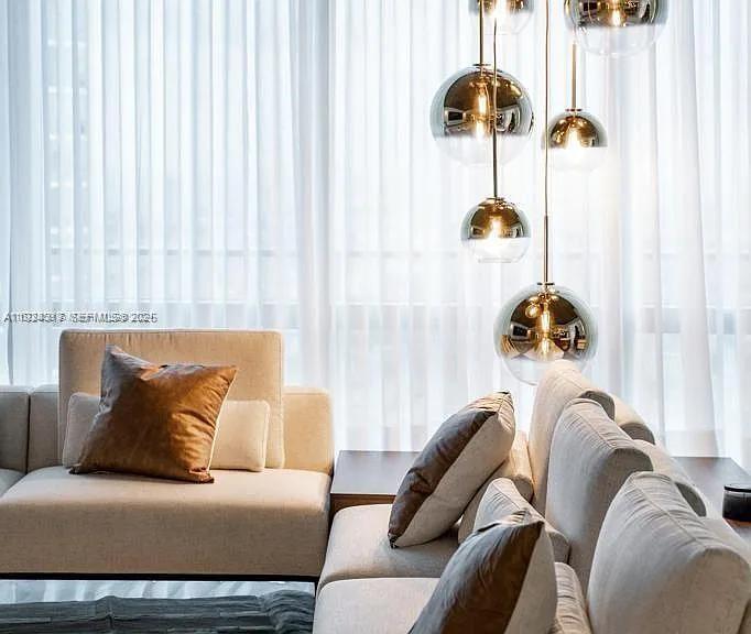 851 Northeast 1st Avenue, Unit 4811 Miami, FL 33132 - Photo 3 of 30 a bedroom with a bed and a chandelier