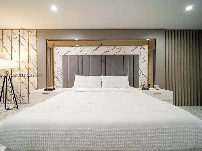 851 Northeast 1st Avenue, Unit 4811 Miami, FL 33132 - Photo 5 of 30 a bedroom with a large bed and a large closet