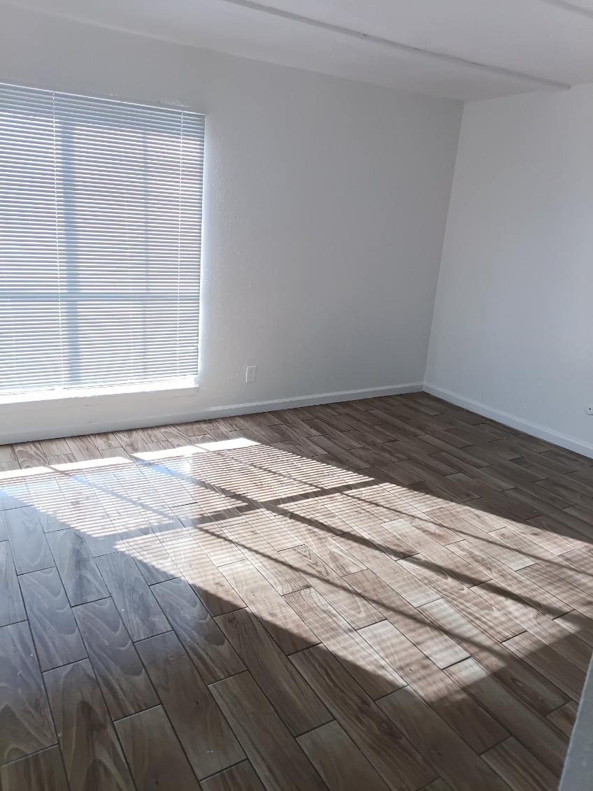 6200 West Tidwell Road, Unit 2306 Houston, TX 77092 - Photo 12 of 15 a view of a room with wooden floor and a window