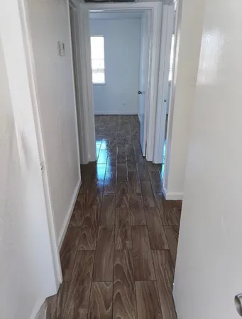 a view of hallway with wooden floor