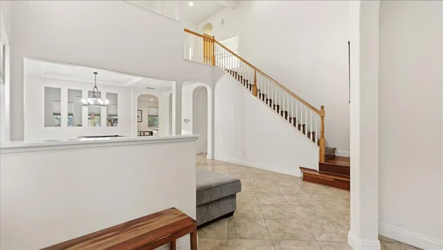 a living room with furniture and stairs