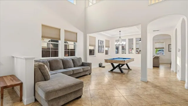 a room with pool table and windows