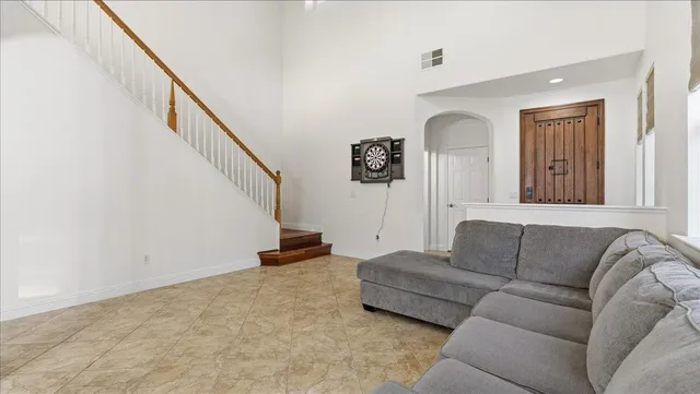a room with chandelier furniture and windows
