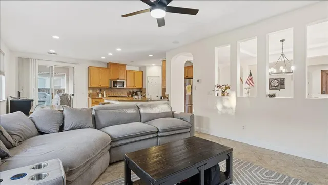 a kitchen with kitchen island granite countertop a sink a counter top space appliances and cabinets