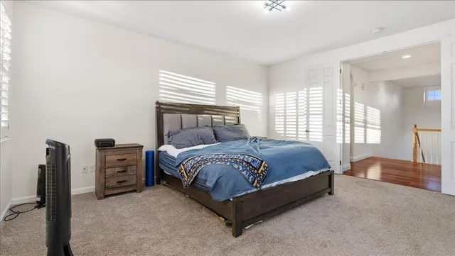 a bathroom with a granite countertop sink a mirror a bathtub and window