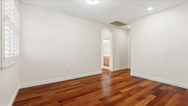 a spacious bathroom with a double vanity sink a mirror and a bathtub