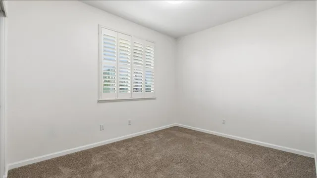 a view of a backyard with plants and outdoor seating