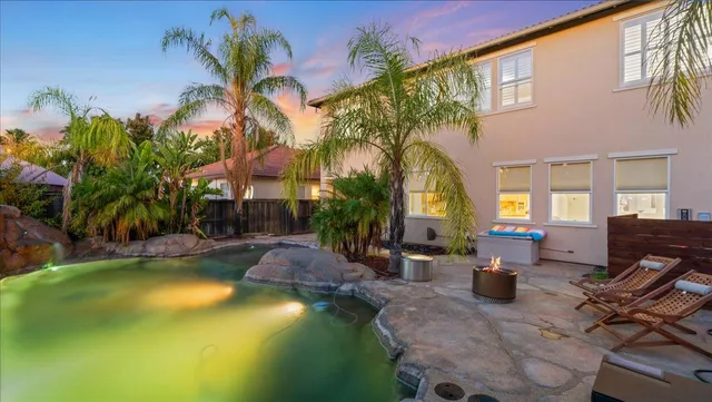 a front view of a house with a garden and plants