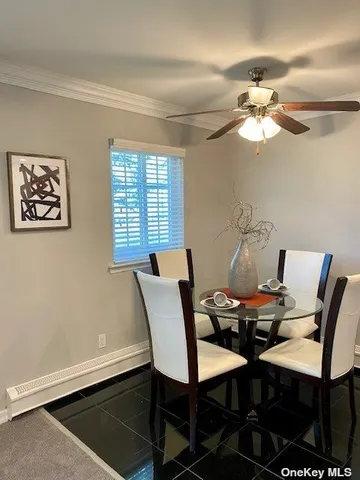 a view of a dining room with furniture and a chandelier