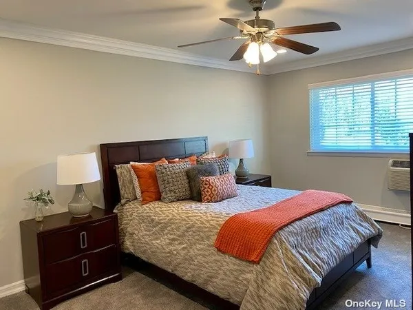 a bedroom with bed and a chandelier