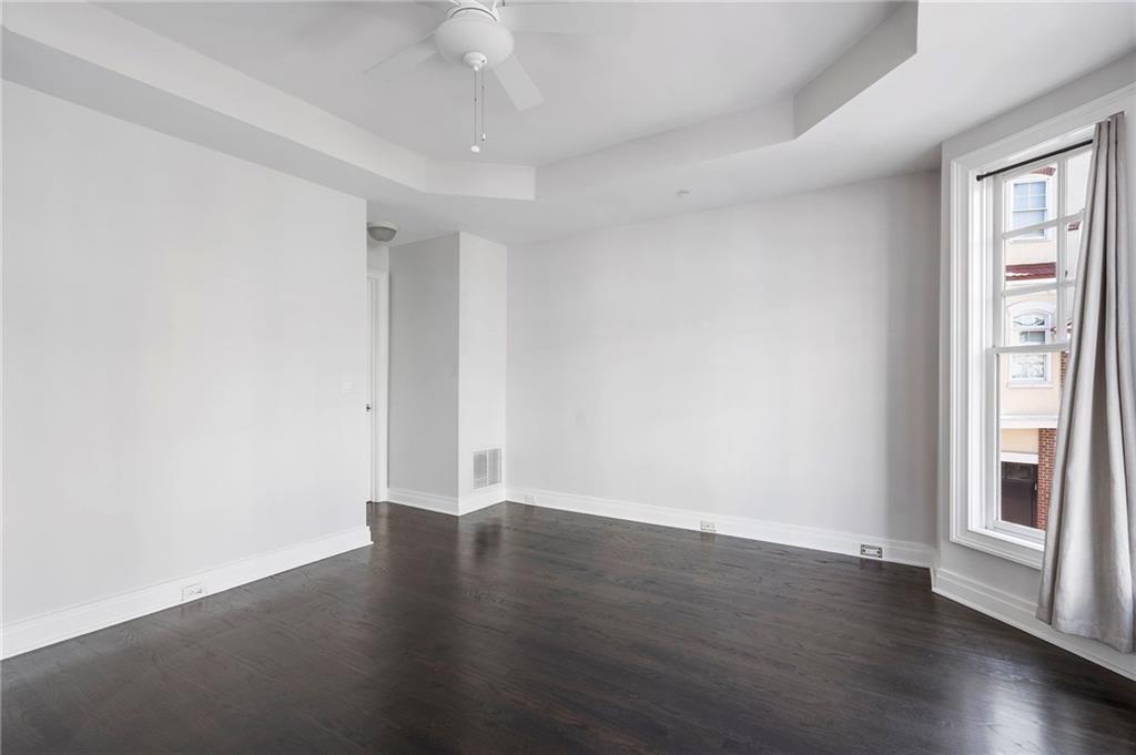3541 Roswell Road Northeast, Unit 4 Atlanta, GA 30305 - Photo 13 of 45 a view of an empty room with wooden floor and a window