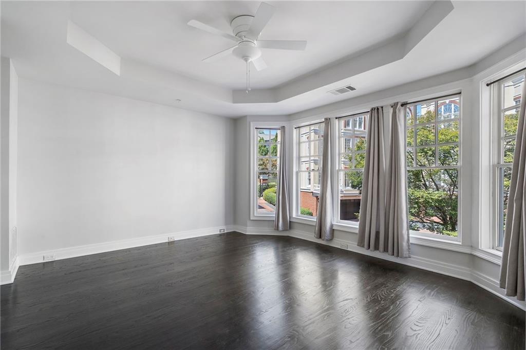 3541 Roswell Road Northeast, Unit 4 Atlanta, GA 30305 - Photo 14 of 45 a view of an empty room with wooden floor and a window