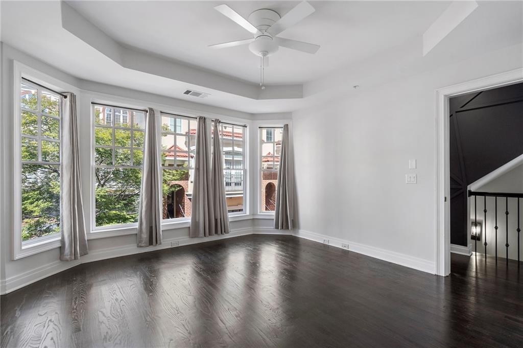 3541 Roswell Road Northeast, Unit 4 Atlanta, GA 30305 - Photo 15 of 45 a view of an empty room with wooden floor and a window