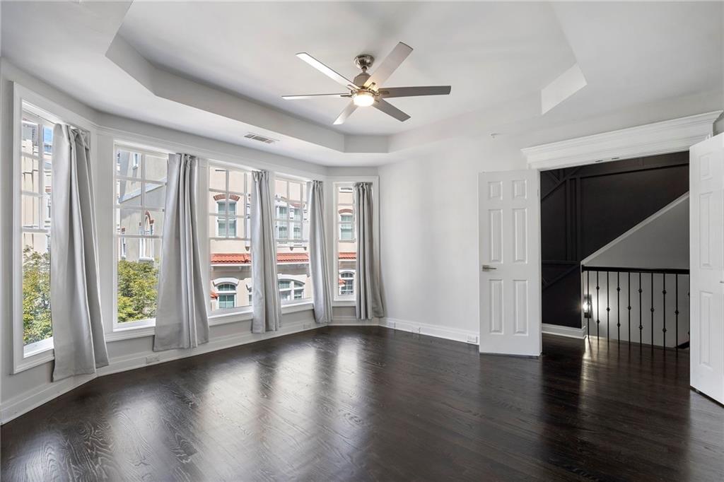 3541 Roswell Road Northeast, Unit 4 Atlanta, GA 30305 - Photo 17 of 45 a view of an empty room with wooden floor and a window
