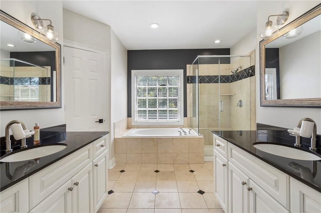 3541 Roswell Road Northeast, Unit 4 Atlanta, GA 30305 - Photo 21 of 45 a bathroom with a granite countertop sink mirror and double