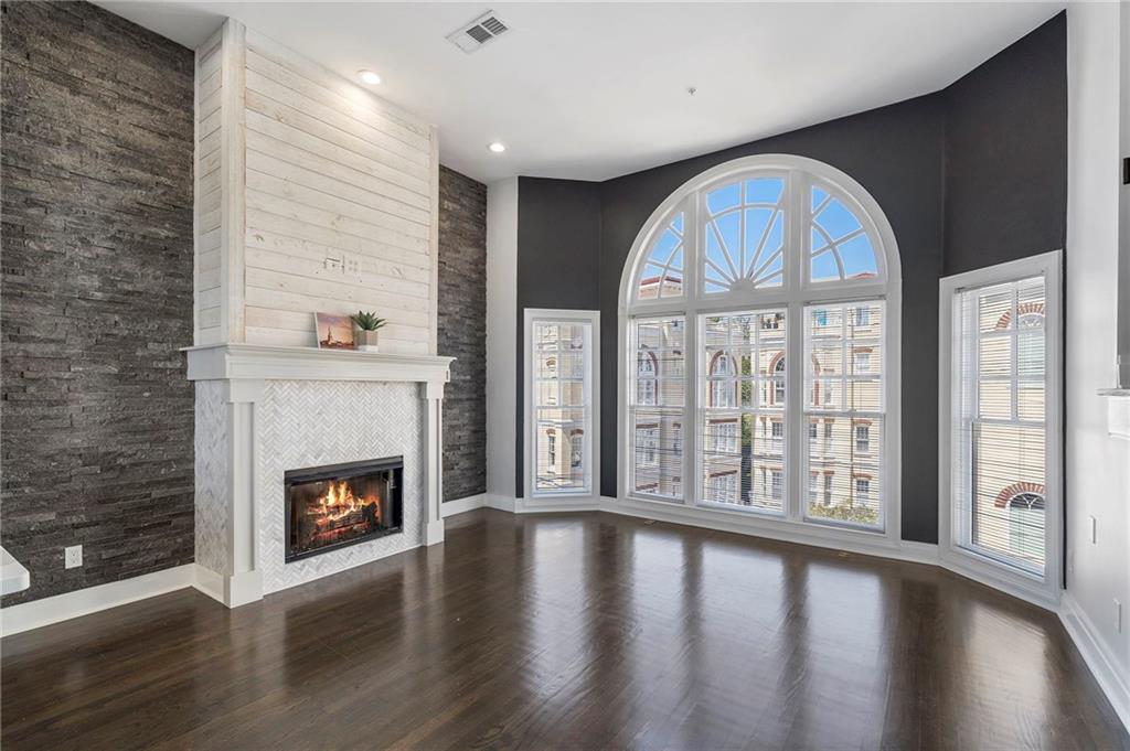 3541 Roswell Road Northeast, Unit 4 Atlanta, GA 30305 - Photo 34 of 45 a view of an empty room with wooden floor and a fireplace