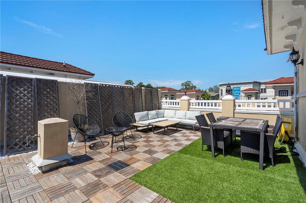 3541 Roswell Road Northeast, Unit 4 Atlanta, GA 30305 - Photo 41 of 45 a view of a patio with table and chairs and potted plants