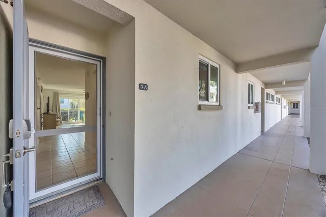a view of a hallway with wooden floor and entryway