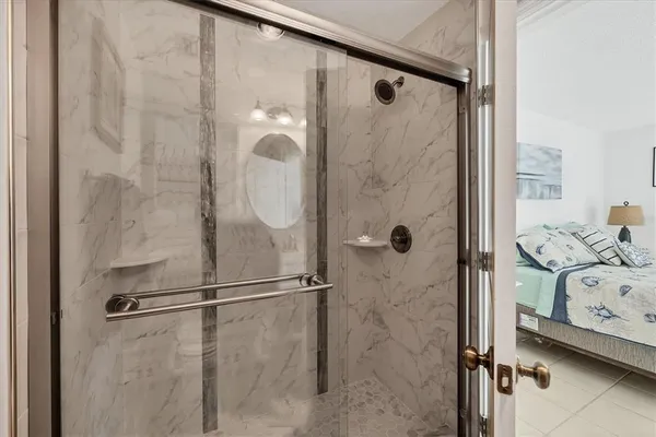a bathroom with a glass shower door