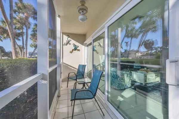a balcony with chairs and outdoor views