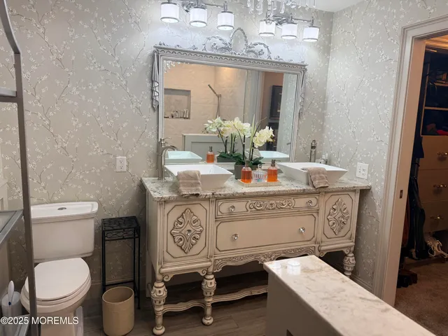 an outdoor sitting area with furniture and umbrella