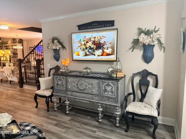 a living room with furniture a fireplace and a chandelier