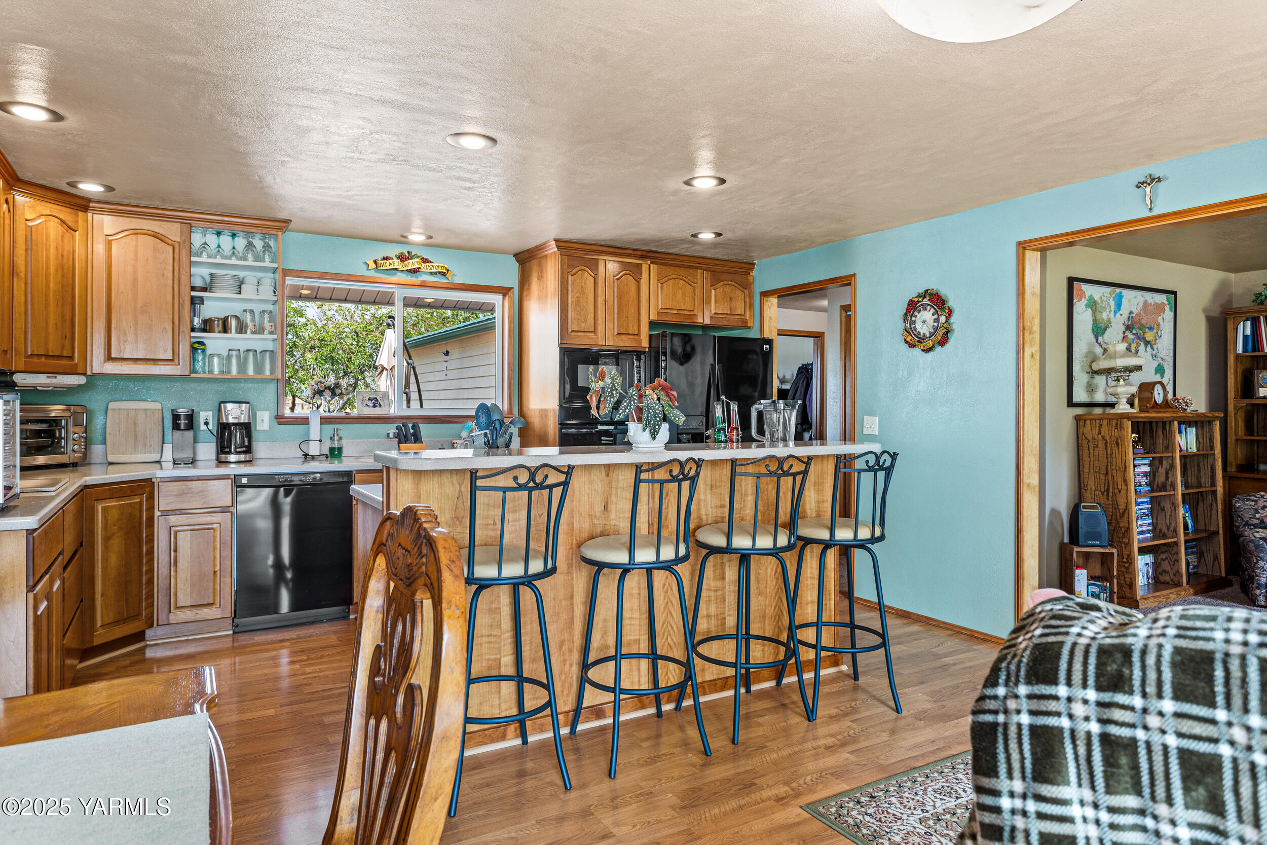 2715 Riverside Road Yakima, WA 98901 - Photo 12 of 35 a kitchen with stainless steel appliances granite countertop a table chairs and a refrigerator