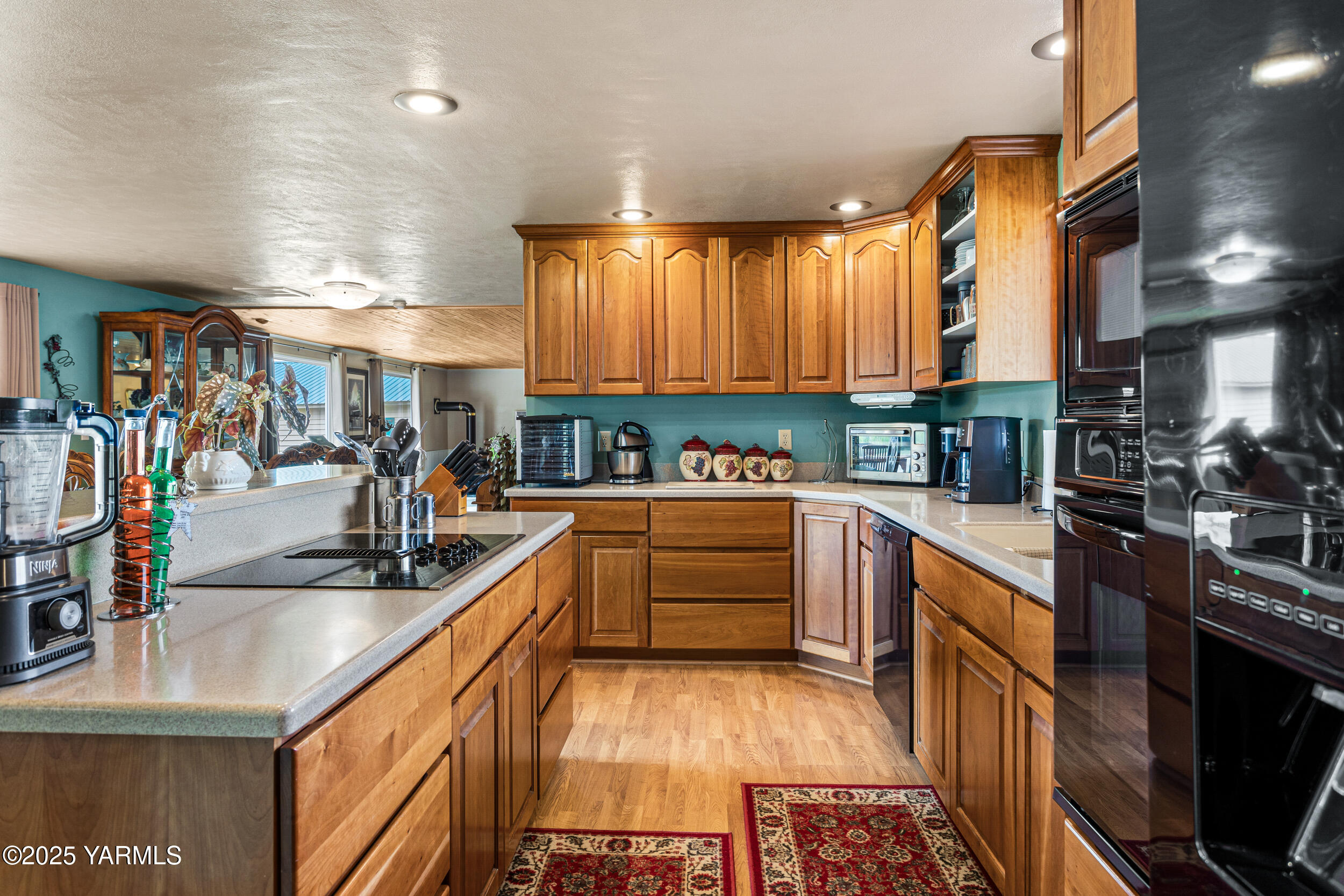 2715 Riverside Road Yakima, WA 98901 - Photo 9 of 35 a kitchen with stainless steel appliances granite countertop a sink and wooden cabinets
