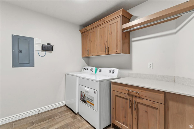 2028 West Grace Way Layton, UT 84041 - Photo 24 of 36 Laundry room featuring electric panel, wood tiled floors, cabinet space, and independent washer and dryer