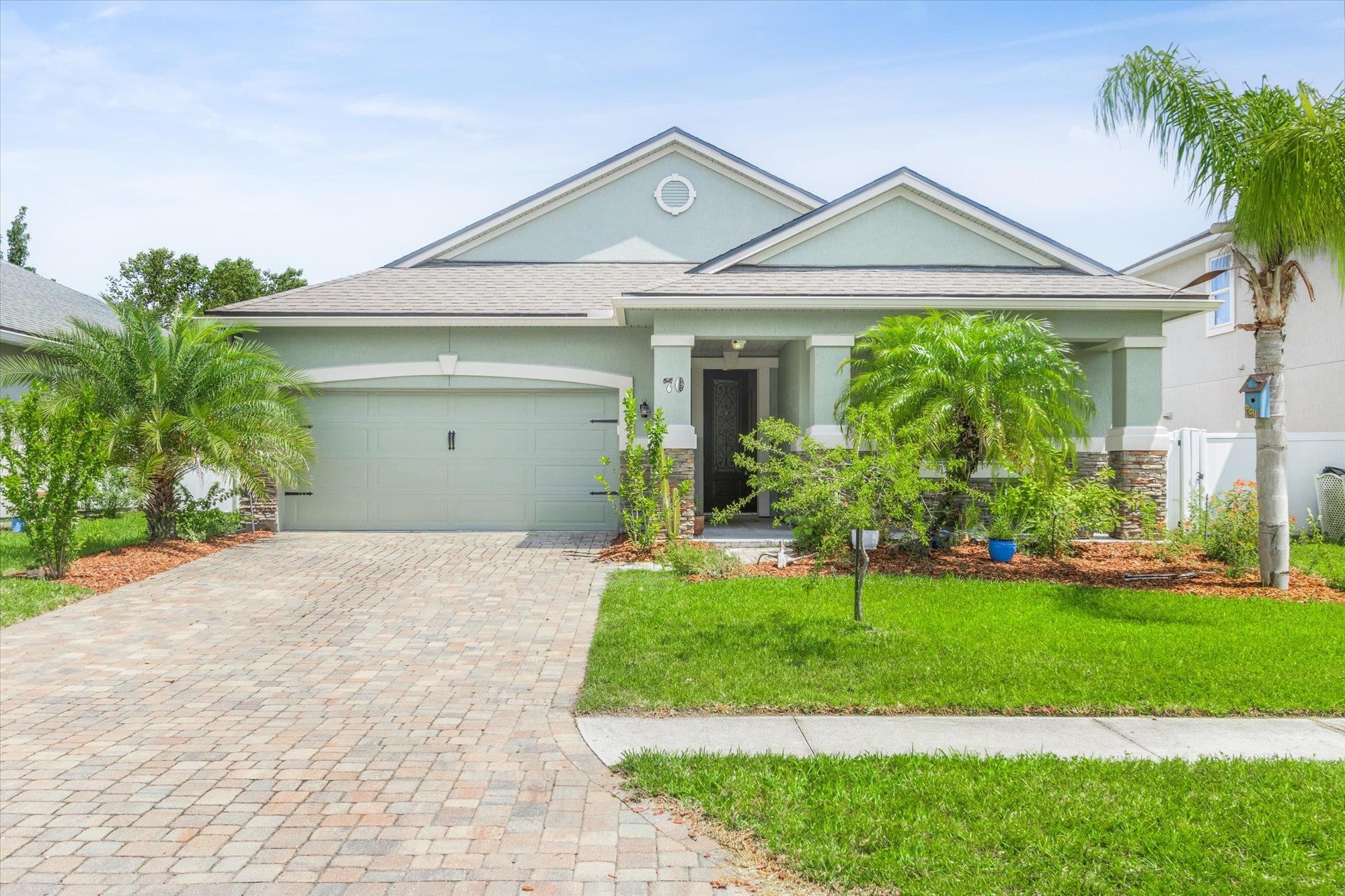 70 Quartz Place St. Augustine, FL 32086 - Photo 1 of 78 a front view of a house with a yard and garage
