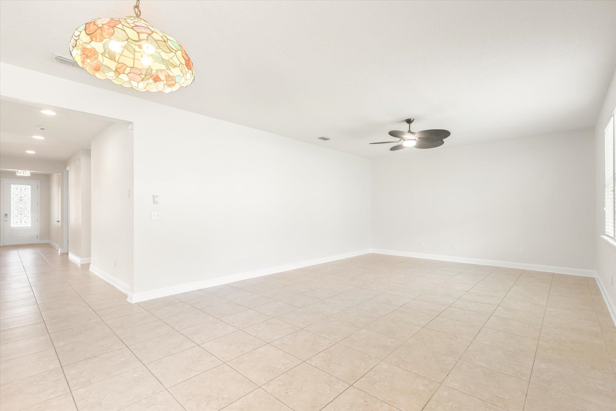 70 Quartz Place St. Augustine, FL 32086 - Photo 11 of 78 an empty room with wooden floor and windows