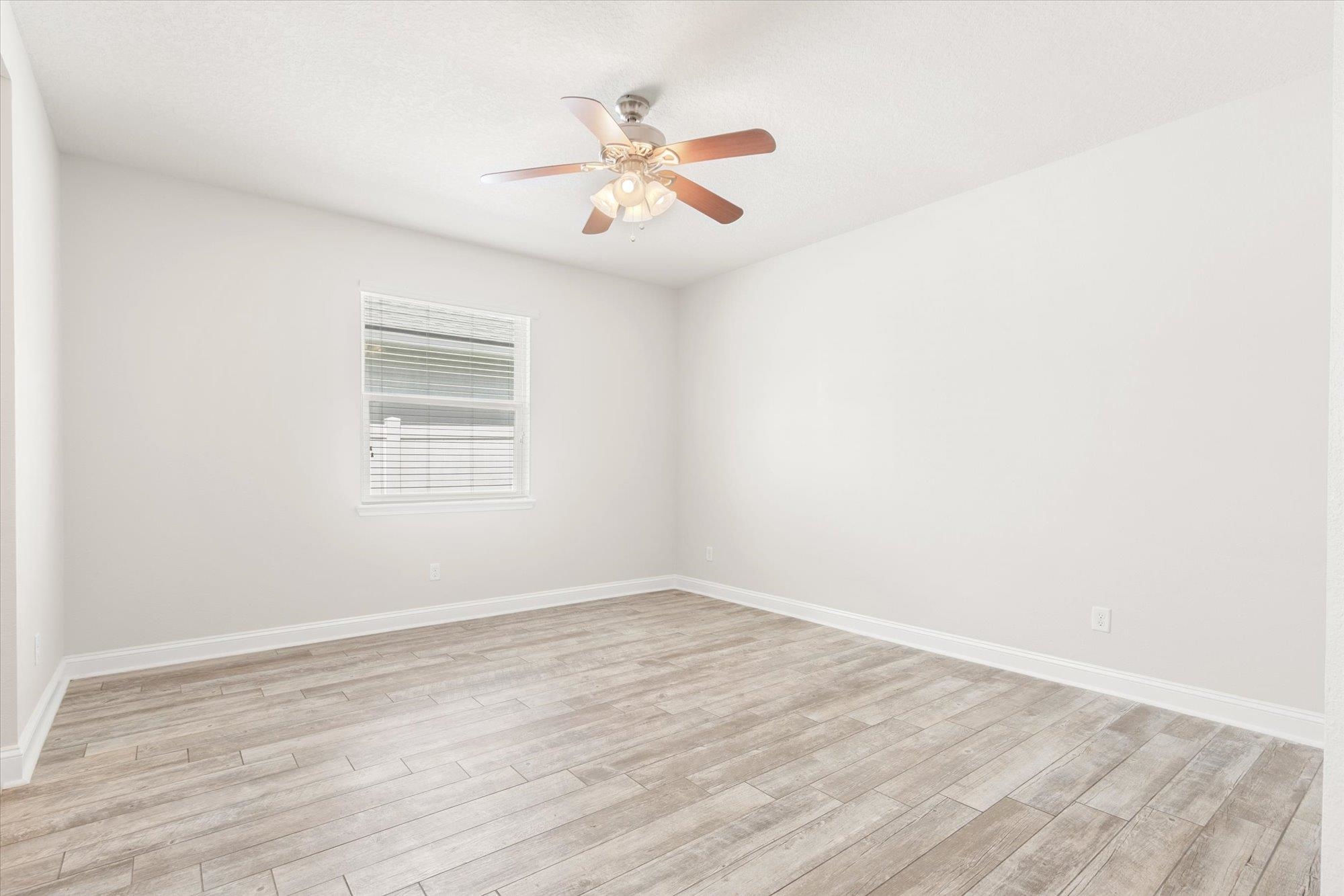 70 Quartz Place St. Augustine, FL 32086 - Photo 16 of 78 an empty room with wooden floor fan and windows