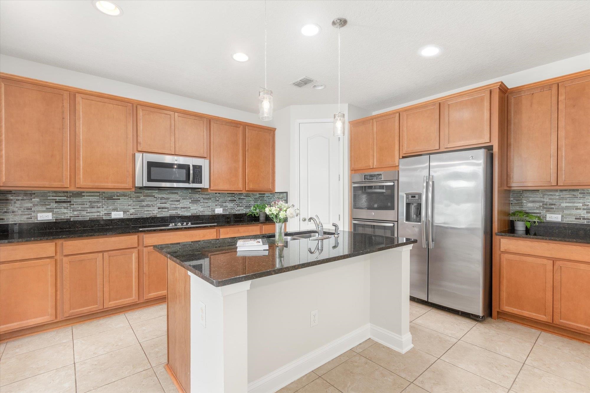 70 Quartz Place St. Augustine, FL 32086 - Photo 2 of 78 a kitchen with stainless steel appliances granite countertop a refrigerator a sink a stove a microwave and island
