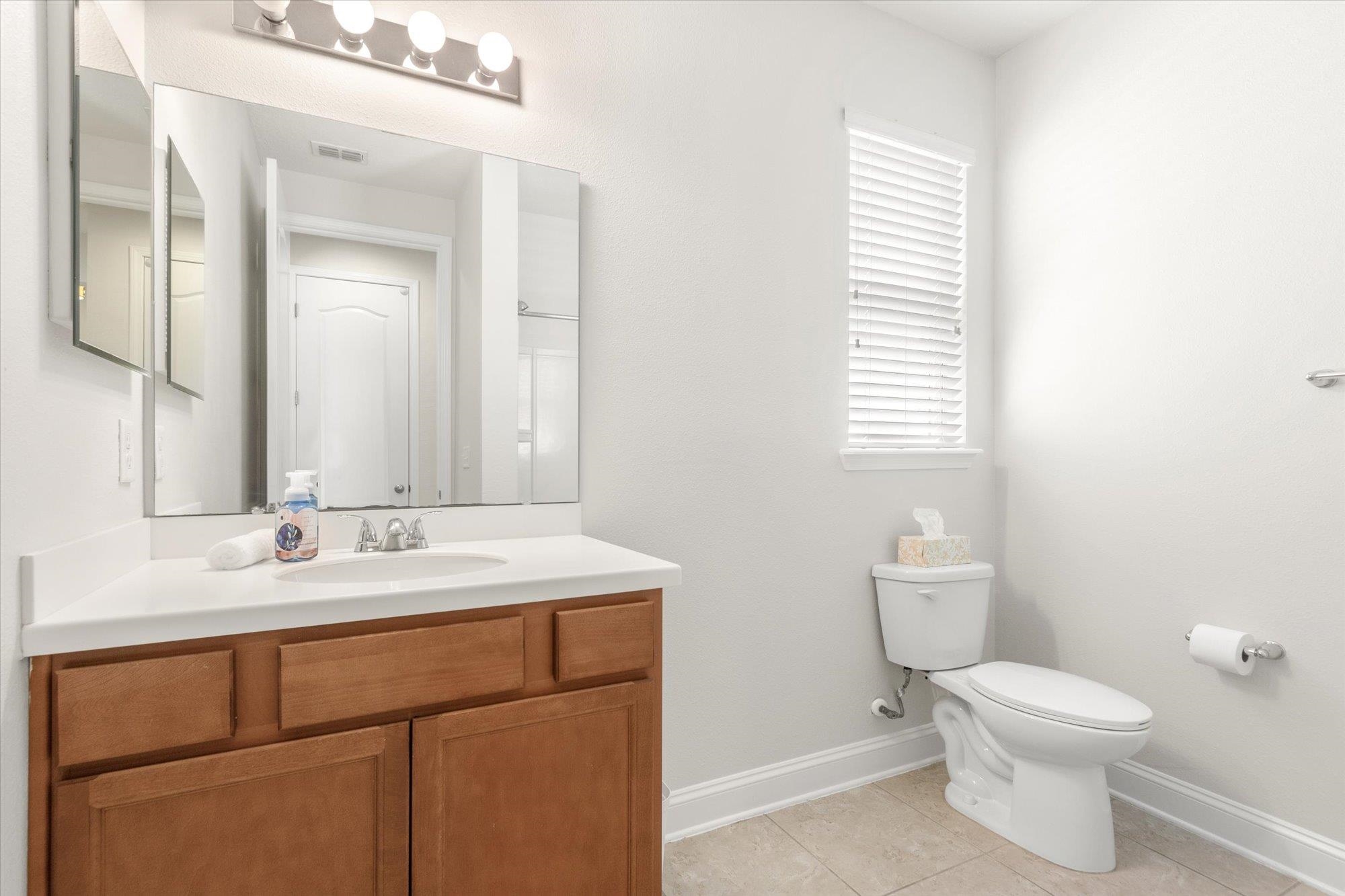 70 Quartz Place St. Augustine, FL 32086 - Photo 26 of 78 a bathroom with a toilet sink and mirror