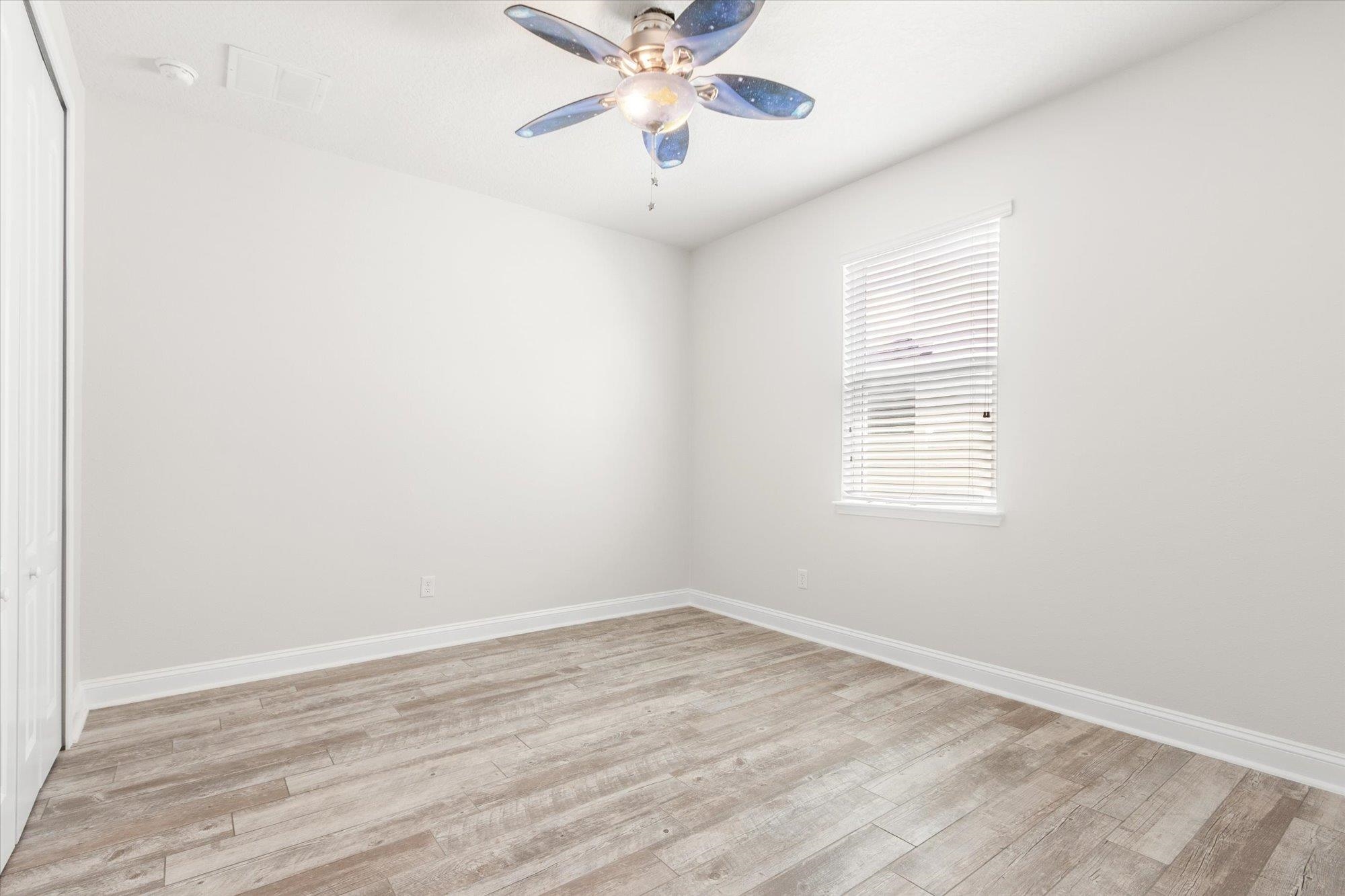70 Quartz Place St. Augustine, FL 32086 - Photo 28 of 78 an empty room with wooden floor chandelier fan and windows