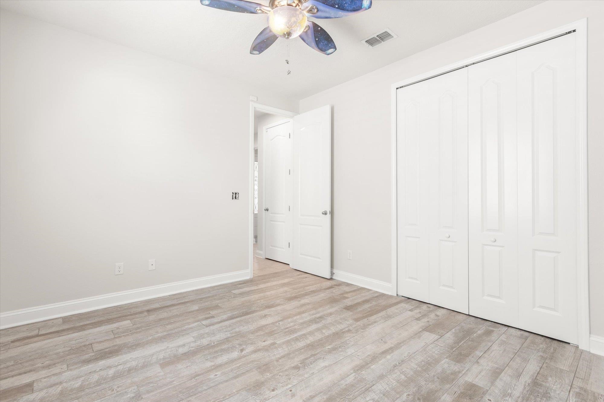 70 Quartz Place St. Augustine, FL 32086 - Photo 29 of 78 an empty room with a ceiling fan and wooden floor