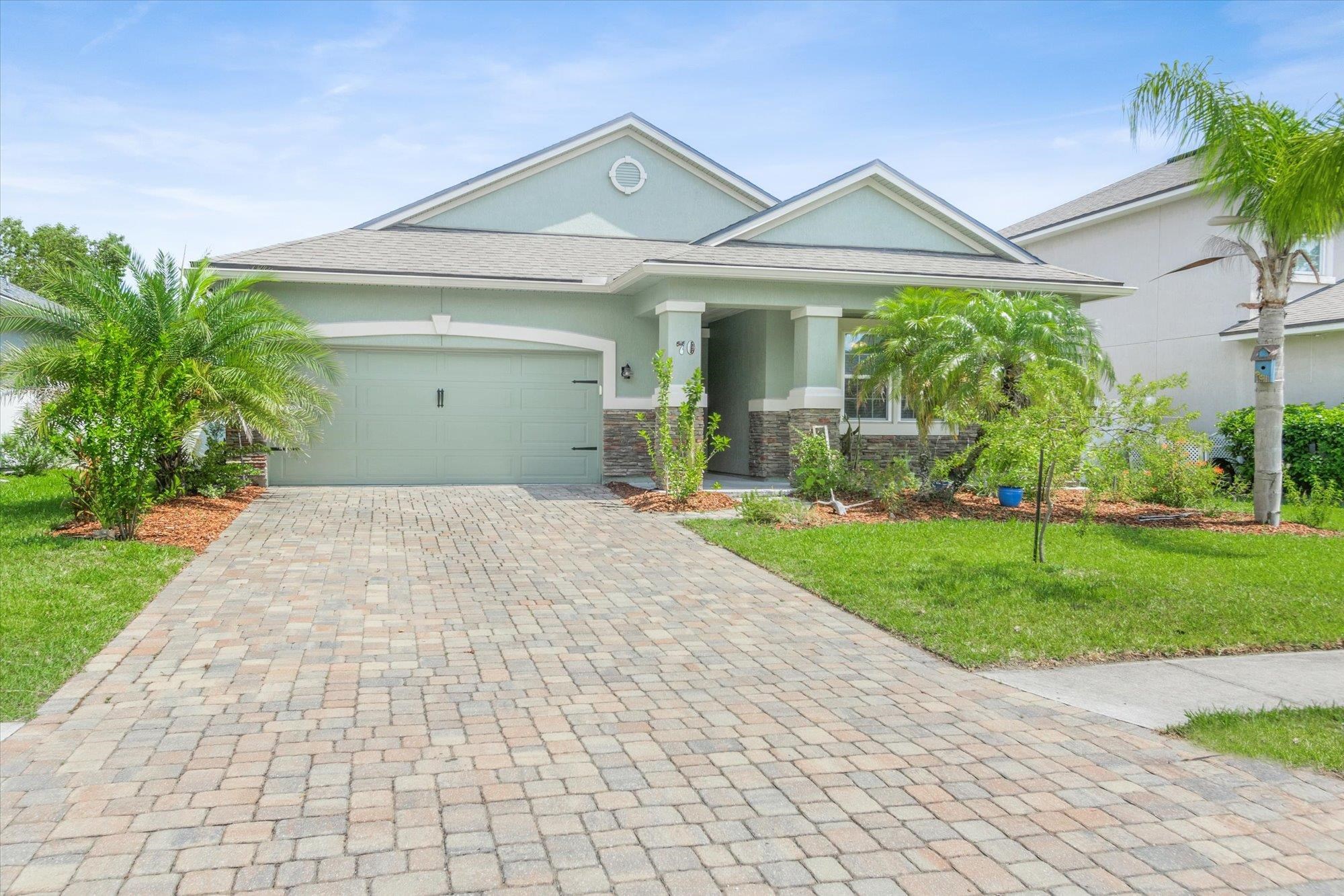 70 Quartz Place St. Augustine, FL 32086 - Photo 32 of 78 a front view of a house with a yard and garage