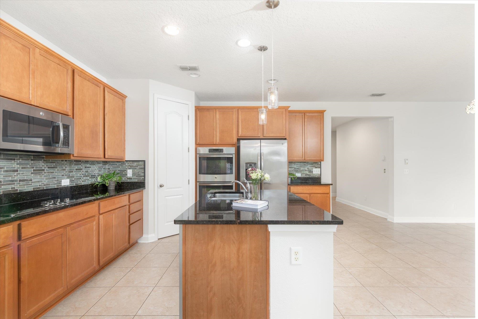 70 Quartz Place St. Augustine, FL 32086 - Photo 5 of 78 a kitchen with stainless steel appliances granite countertop a sink and a stove