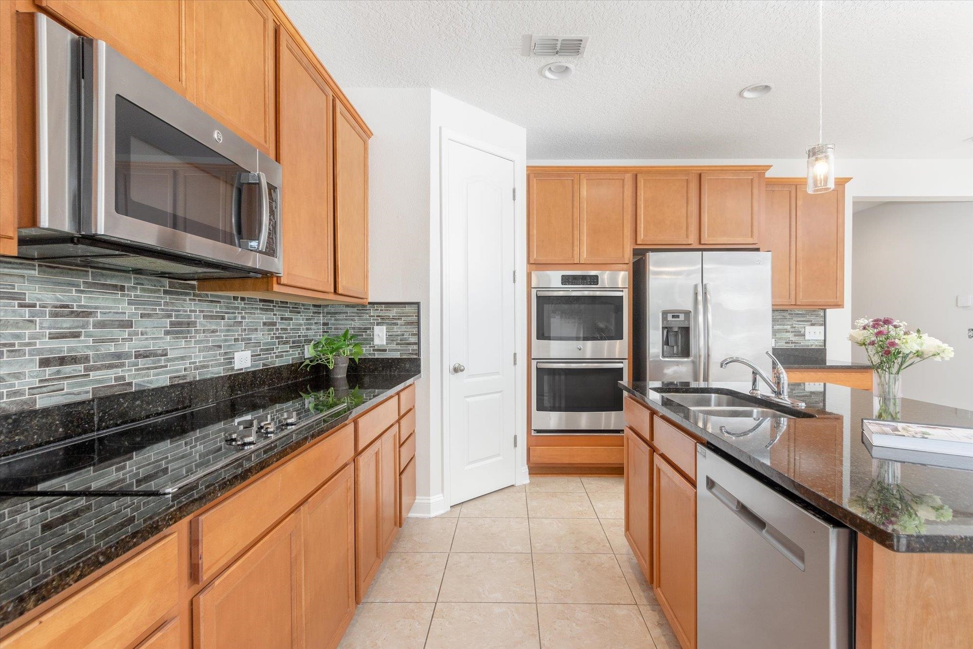 70 Quartz Place St. Augustine, FL 32086 - Photo 7 of 78 a kitchen with granite countertop a sink stainless steel appliances and cabinets