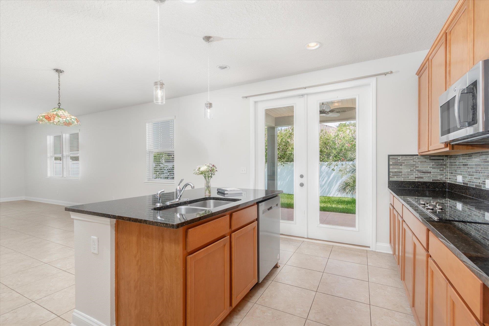 70 Quartz Place St. Augustine, FL 32086 - Photo 8 of 78 a kitchen with stainless steel appliances granite countertop a stove a sink and a refrigerator