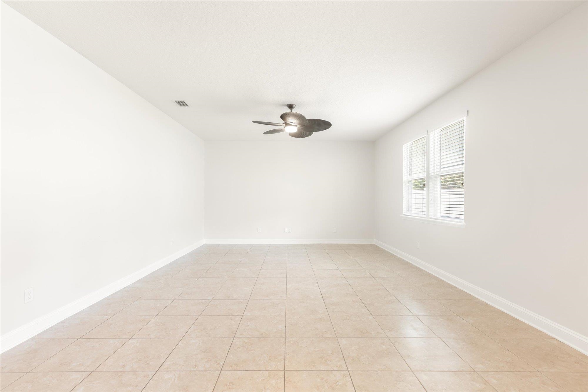 70 Quartz Place St. Augustine, FL 32086 - Photo 10 of 78 an empty room with a ceiling fan and window